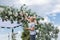 Young girl florist decorates the festive chuppah for the wedding ceremony with flowers