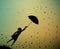 Young girl flying away with an umbrella, autumn wind,