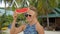 Young Girl Fooling with Peace of Watermelon on the Beach. Hipster Carefree Funny Footage. HD Slowmotion. Thailand.