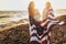 Young girl friends enjoys a sunny day on the beach. They`re holding an american flag