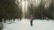 Young girl funny walks in the winter wood