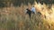 Young girl galloping on autumn field near the forest