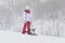 Young girl getting ready to sled from the descent