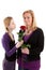 Young girl gives rose to mother