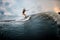 Young girl glides on a wakeboard in the river near forest