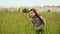 Young girl goes in deep grass
