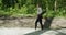 Young girl goes for yoga training in nature calm mood. Woman relaxes in a city nature park. Slow motion