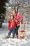 Young Girl With Grandmother Holding Sledge