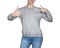 Young girl in gray sweatshirt shows thumbs up. white background