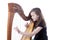 Young girl in green pants plays harp in studio