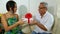 Young girl handing present to her father