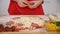 Young girl hands place salami slices on pizza