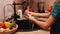 Young girl hands washing vegetables at the kitchen sink