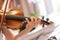 Young girl happily plays on her violin