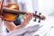 Young girl happily plays on her violin