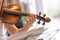 Young girl happily plays on her violin