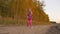 Young girl happy jumping outdoors. Dancing hip-hop near golden forest autumn sunset. Slow motion.