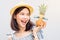 Young girl happy smile and cheerful in blue dress and hold pineapple in hand