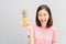 Young girl happy smile and cheerful in red dress and hold two pineapple in hand.