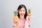 Young girl happy smile and cheerful in red dress and hold two pineapple in hand. Concept summer travel.