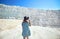 Young girl in hat looking on travertine pools and terraces in Pamukkale. Cotton castle in southwestern Turkey