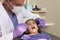 Young Girl Having Check Up At Dentists Surgery