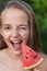 Young girl having fun with a healthy slice of watermelon