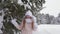 Young girl having fun in winter woods.