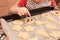 Young girl helps mother prepare cookies before the holiday