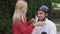 Young girl helps to guy to put a helmet