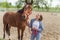 Young Girl With Her Bay Horse Standing In The Stable Girl Holding Horse Lead Rope