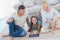 Young girl and her parents using a tablet