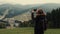 Young girl hiker is shooting video of beautiful misty mountain landscape on mobile phone camera.