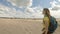 Young girl hiking in dunes. Slow motion.