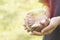 Young girl hold glass bottle of coins to save money and donation concept