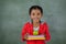 Young girl holding apple and books