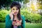 Young girl holding coloful fruits salad bowl in public park with