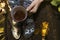 Young girl holding and drink tea in the forest, wears socks with the deers. Autumn cozy mood and fall concept. View from above