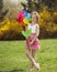 Young girl holding large Flower shaped wind wheel