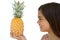 Young girl holding pineapple and smiling