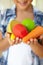 Young girl holding plastic fruit and vegetables