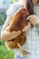 Young girl holds and hugs beautiful brown hen.