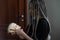 a young girl holds a skull in her hands and looks at it