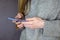 Young girl holds smartphone in her hands. She browses website information on mobile phone screen.