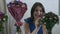 A young girl at home puts bouquets of flowers in a cart with water and speaks on the phone