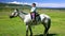 Young girl on horseback in Mongolian landscape