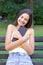 Young girl is hugging her favourite textbook in the park