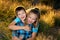 Young Girl Hugs Her Younger Brother From Behind For a Portrait i