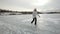 Young girl ice skating on frozen lake