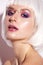 Young girl in the image of a fantasy with a piercing. Beautiful model in a white wig with bob and bright makeup. Beauty face.